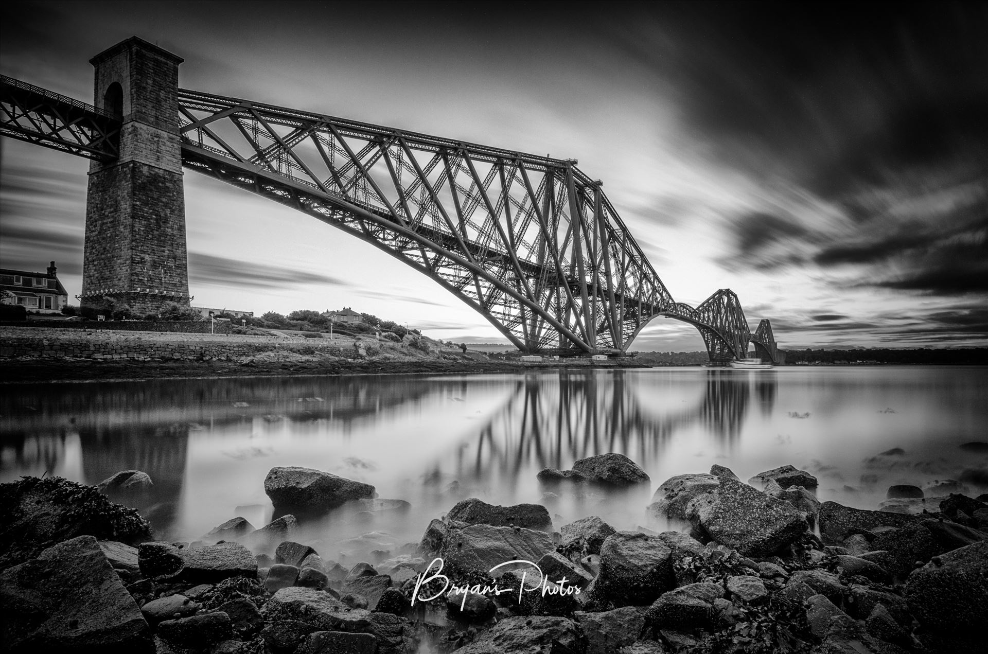 The Bridge Black and White - A black and white long exposure photograph of the iconic Forth Rail Bridge taken on a summer evening from North Queensferry on the banks of the river Forth. by Bryans Photos