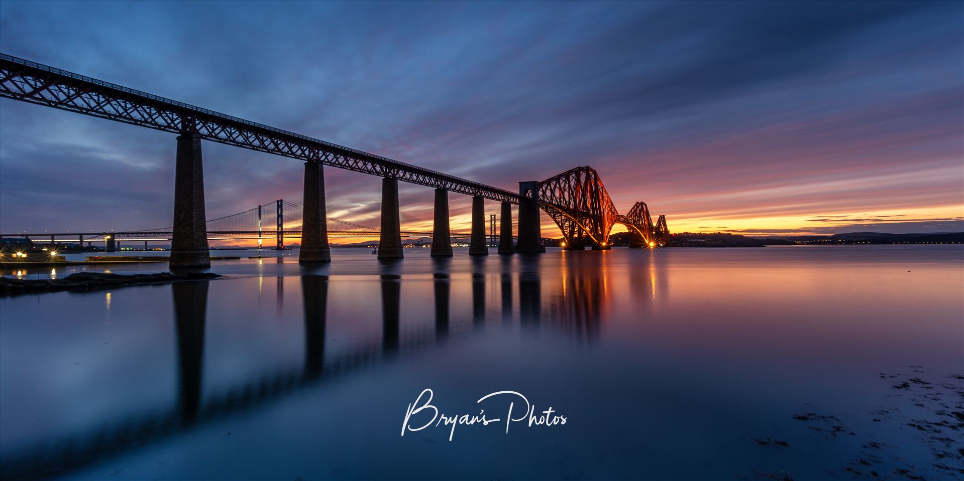 South Queensferry Sunset Panorama - A panoramic photograph of the Forth Rail Bridge taken at sunset from the banks of the river Forth at South Queensferry. by Bryans Photos