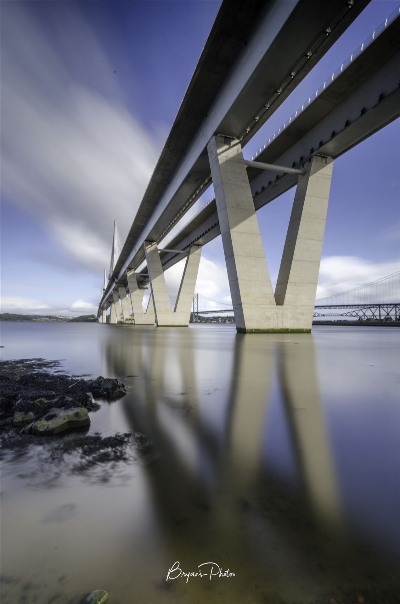 Queensferry Crossing Portrait - A long exposure photograph of the Queensferry Crossing taken from the south bank of the river Forth at high tide. by Bryans Photos