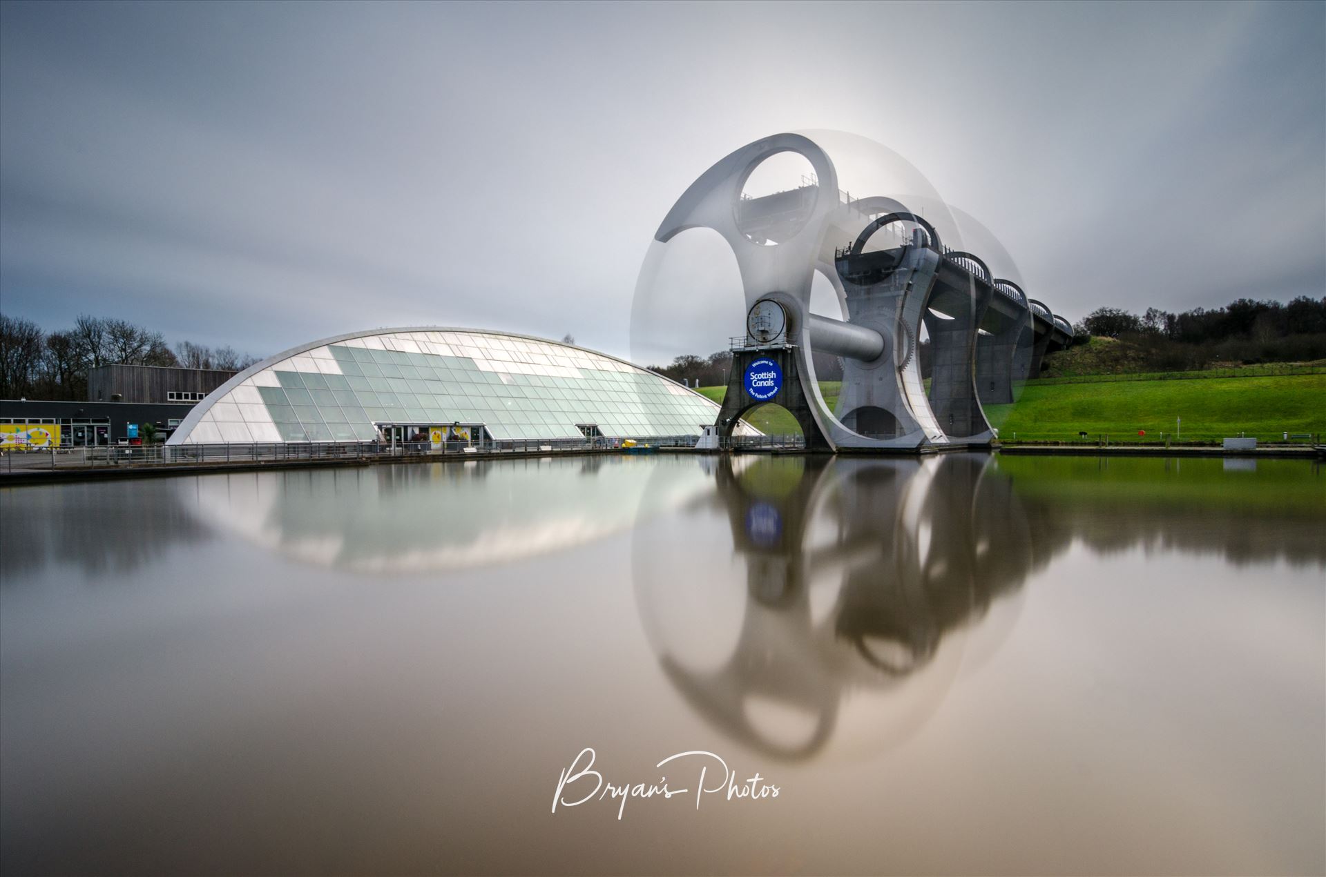 Falkirk Wheel In Motion - A long exposure photograph of the Falkirk Wheel capturing the movement of the wheel as it lifts boats between the Forth and Clyde and Union canals. by Bryans Photos