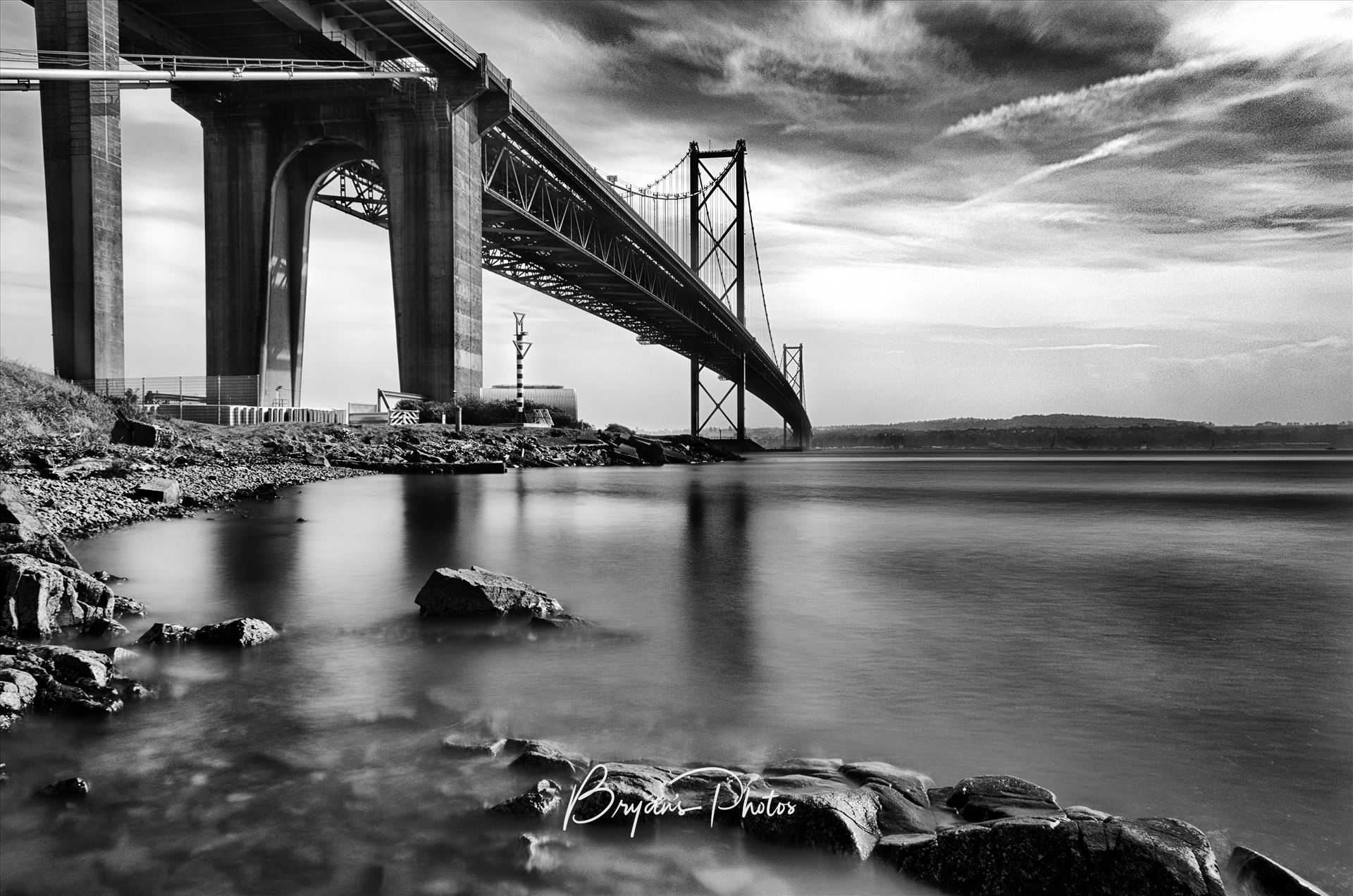 Forth Road Bridge - A daytime long exposure of the Forth Road Bridge taken from North Queensferry in black and white. by Bryans Photos