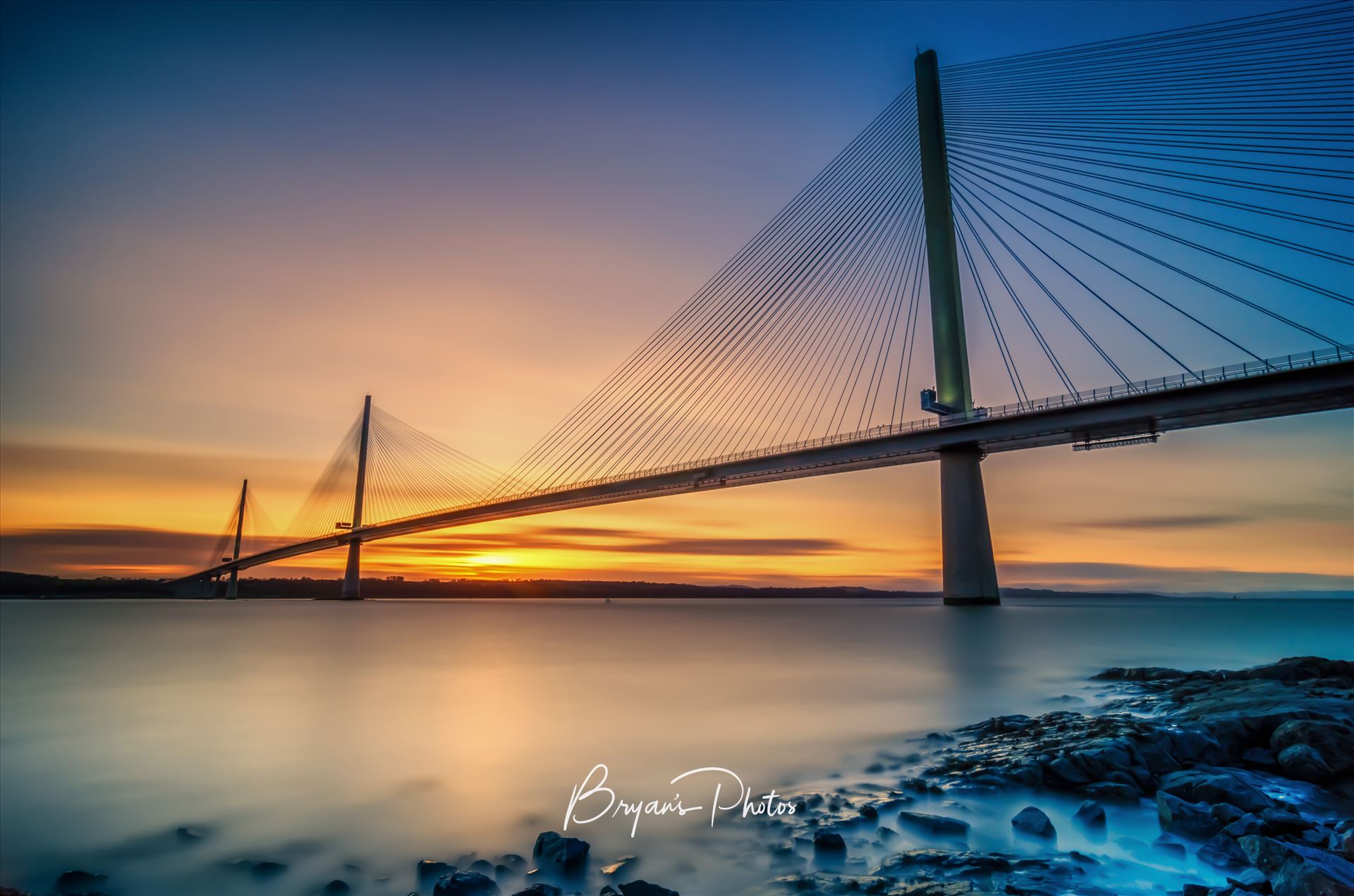 Queensferry Sunset - A long exposure photograph of the Queensferry Crossing taken from North Queensferry on the Fife Coast. by Bryans Photos