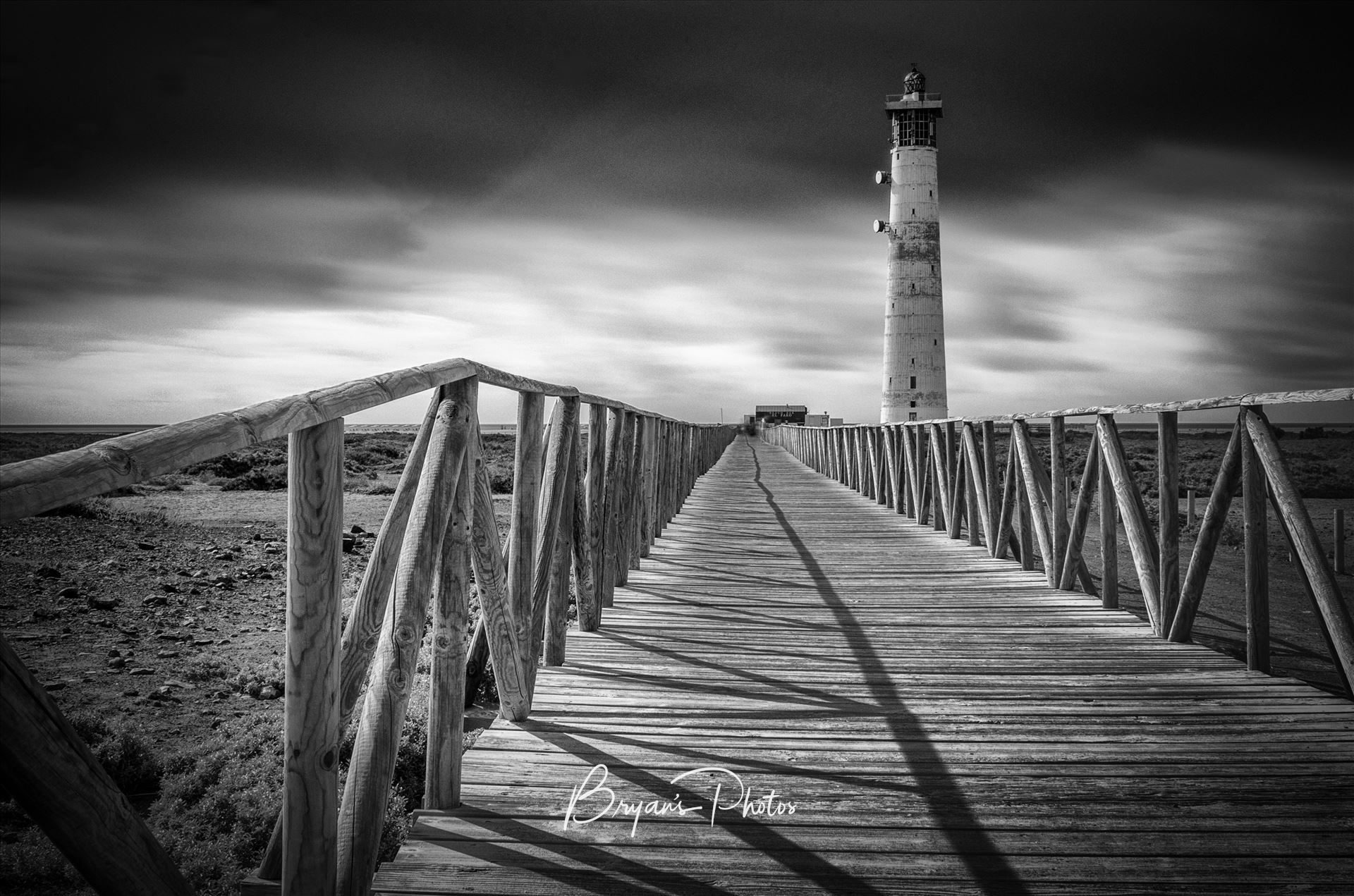 Morro Jable Lighthouse - A black and white long exposure photograph of the lighthouse at Morro Jable Jandia Fuerteventura. by Bryans Photos