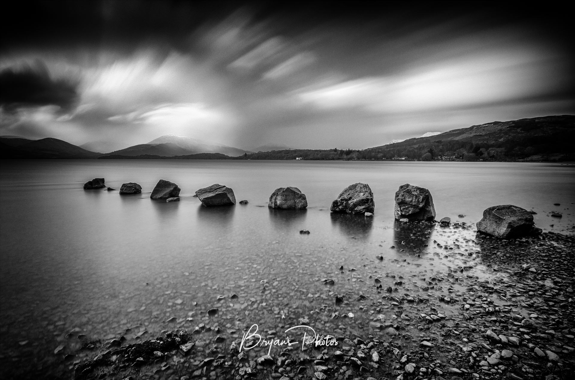 Rocks At Milarrochy - A black and white long exposure photograph of Loch Lomond taken from Milarrochy Bay. by Bryans Photos