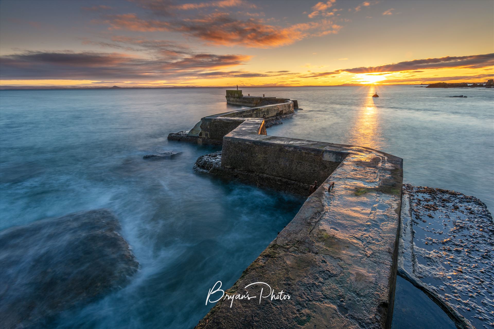 East Neuk Sunset - A photograph of the St Monans breakwater taken at Sunset. by Bryans Photos