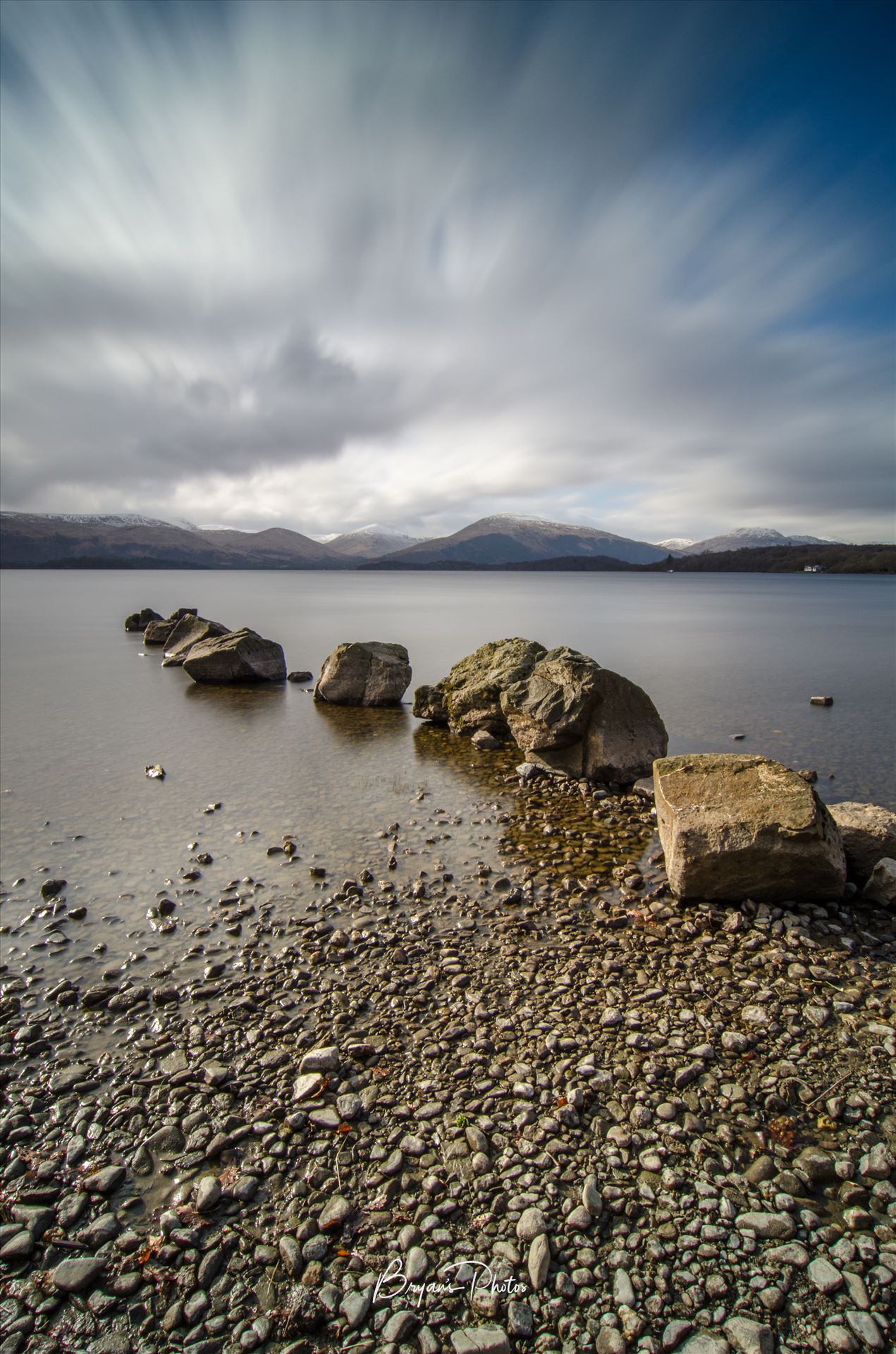 Loch Lomond at Milarrochy Bay - A long exposure photograph of Loch Lomond taken from Milarrochy Bay. by Bryans Photos