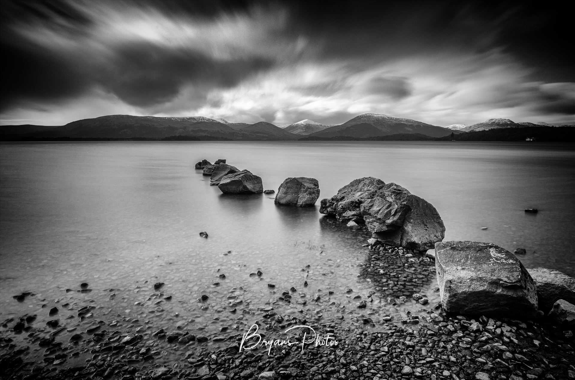 Milarrochy Bay Loch Lomond - A black and white long exposure photograph of Loch Lomond taken from Milarrochy Bay. by Bryans Photos