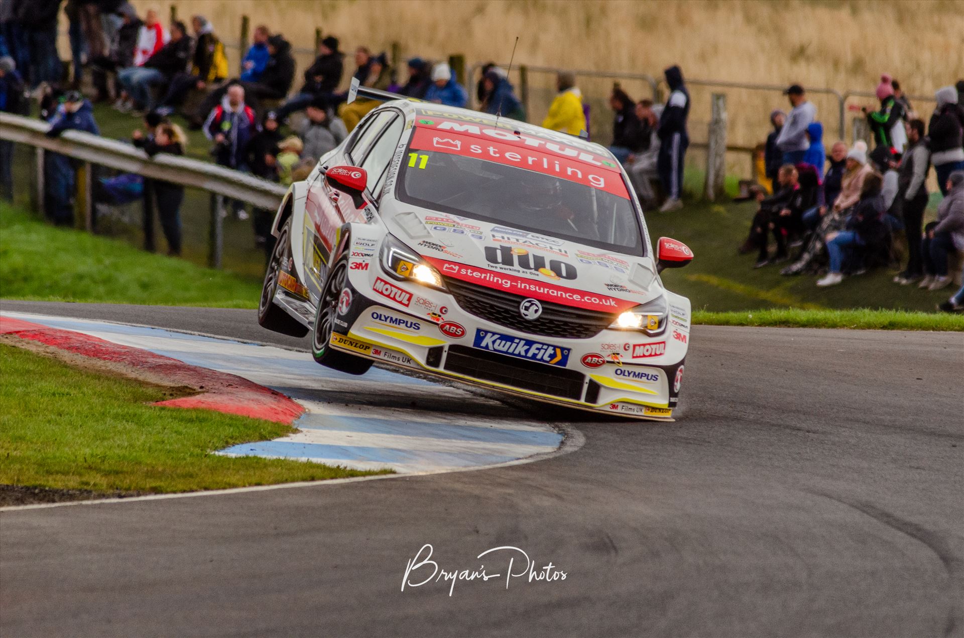 Jason Plato - A photograph of Jason Plato getting his Astra on two wheels during qualifying for the 2019 touring cars race at Knockhill racing circuit. (photograph taken from public access area) by Bryans Photos