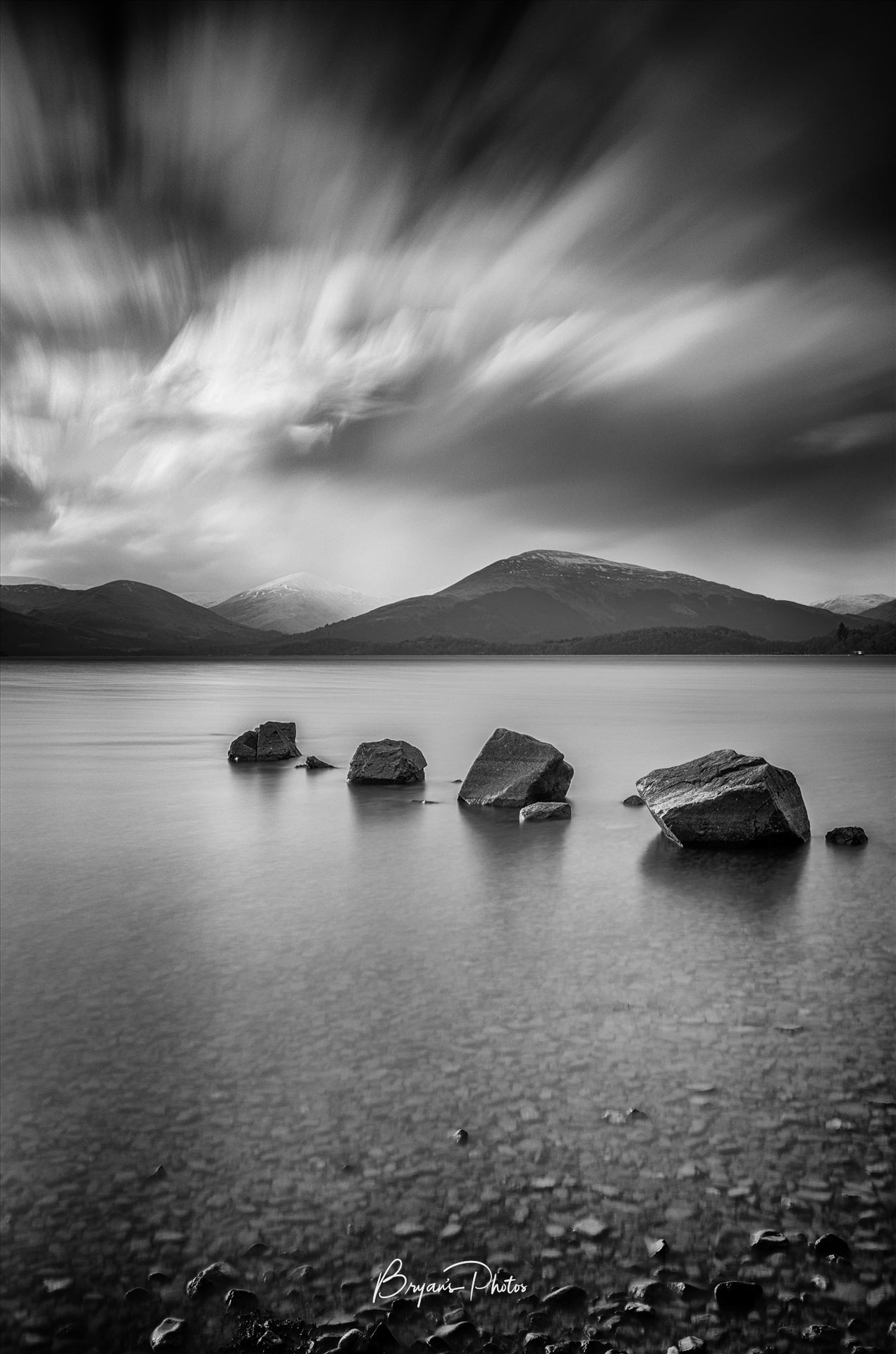 Loch Lomond - A black and white long exposure photograph of Loch Lomond taken from Milarrochy Bay. by Bryans Photos