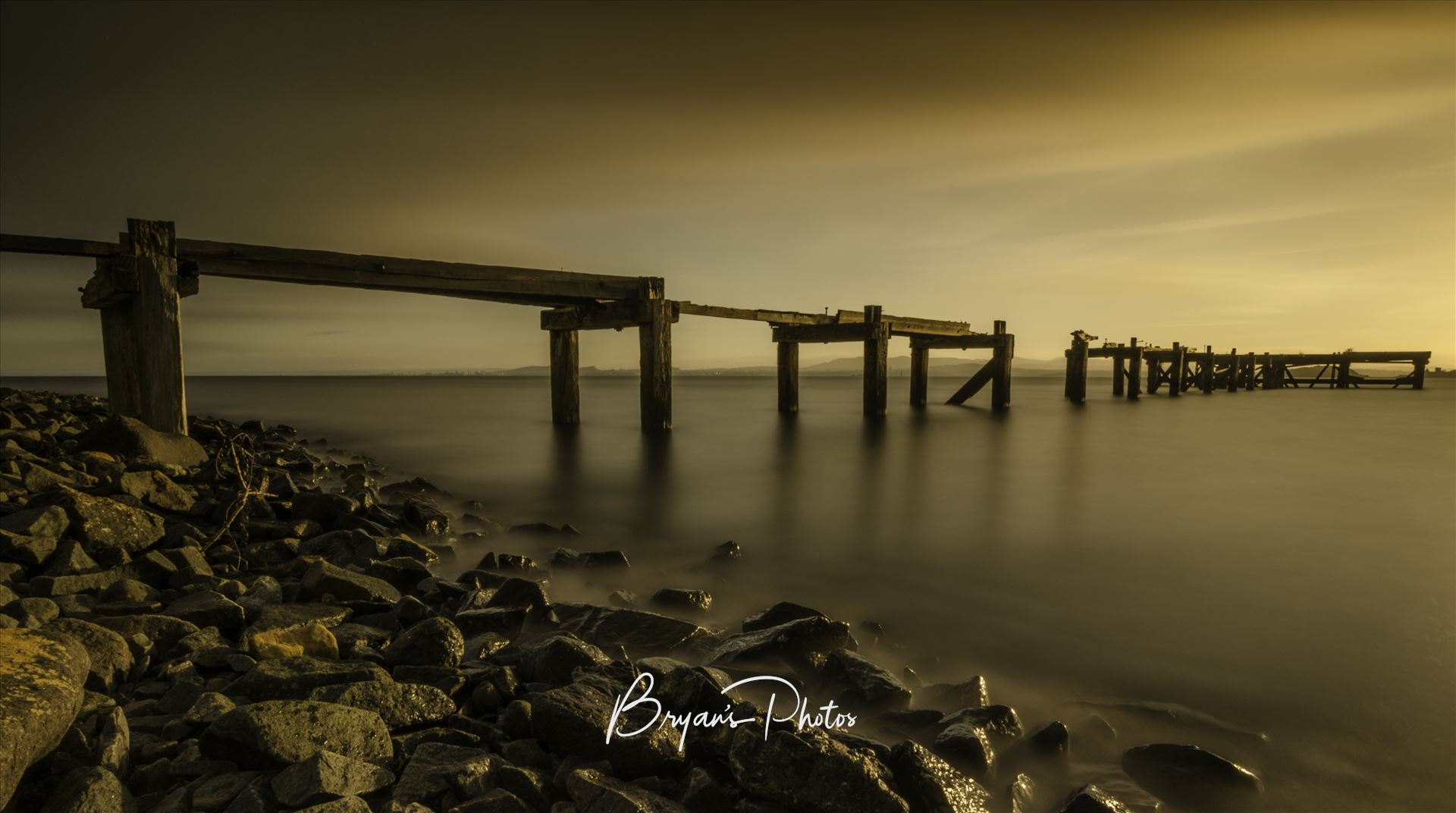 Aberdour Sunset - A long exposure photograph of the abandoned pier at Aberdour taken at sunset. by Bryans Photos