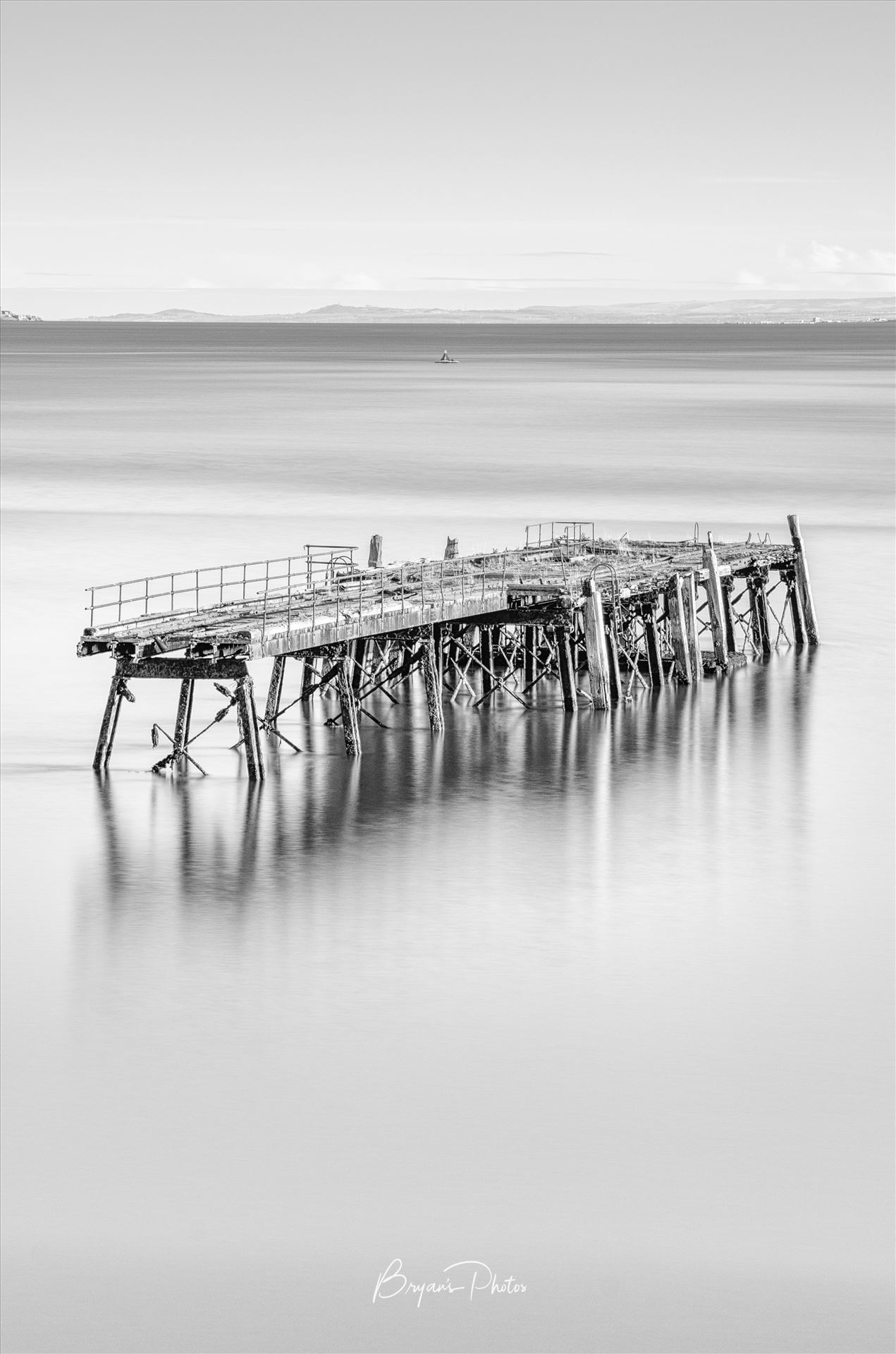 Carlingnose Pier - A black and white photograph of the remains of Carlingnose Pier on the Fife coast of Scotland. by Bryans Photos