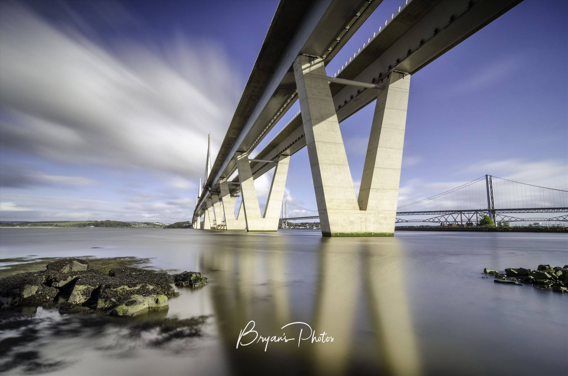 The Crossing Landscape - A long exposure photograph of the Queensferry Crossing taken from the south bank of the river Forth at high tide. by Bryans Photos