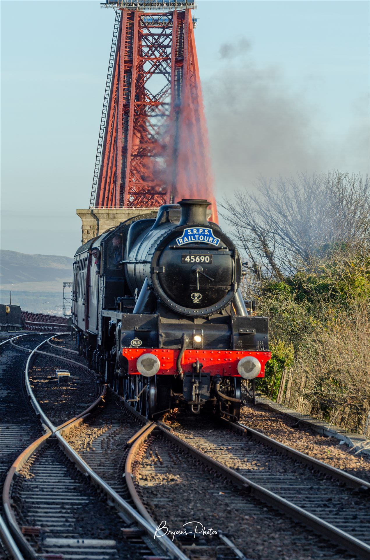 Leander and the Bridge - A photograph of the LMS Jubilee Class Leander Steam Train with the Forth Rail Bridge in the background taken from North Queensferry. by Bryans Photos