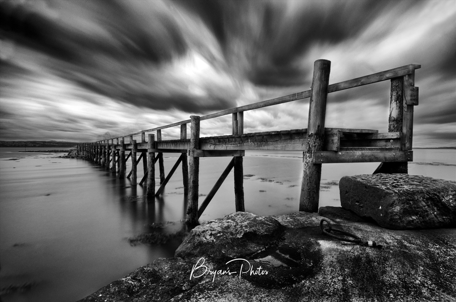 Historic Pier at Culross - A black and white photograph of the historic pier at Culross on the Fife Coast. Culross harbour is one of the oldest in Scotland and the pier is being restored to it's former state. by Bryans Photos