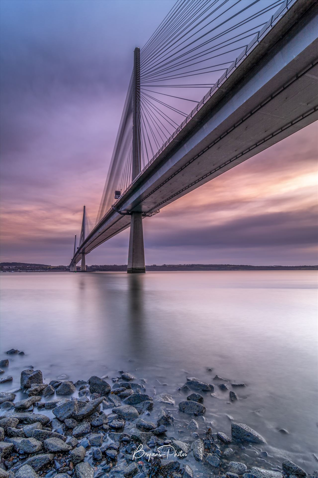 The Crossing - A portrait photograph of the Queensferry Crossing taken from North Queensferry at sunset. by Bryans Photos