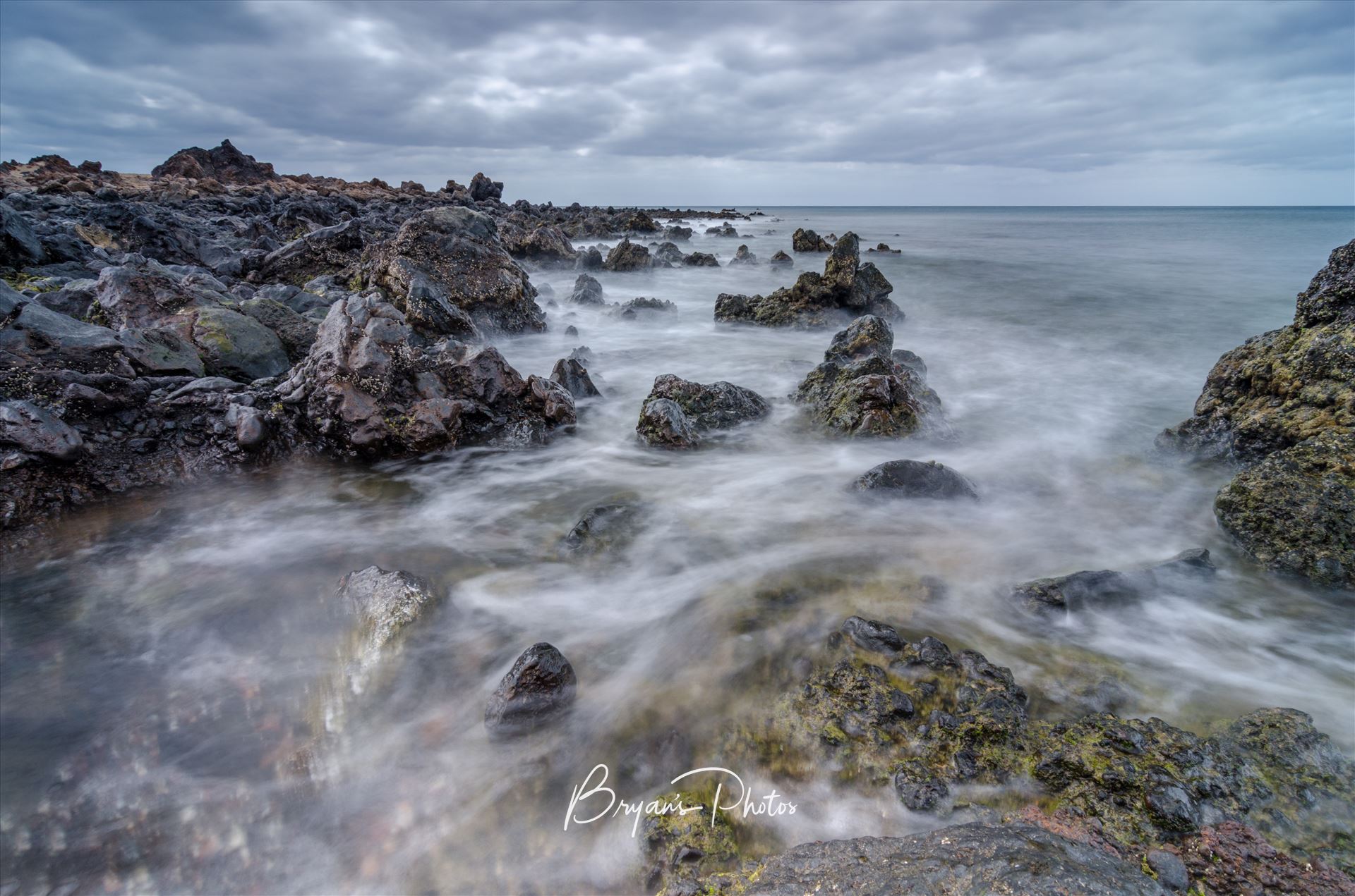 Volcanic Seascape - A photograph taken from the beach at Los Piccolos Lanzarote looking out over the Atlantic Ocean. by Bryans Photos