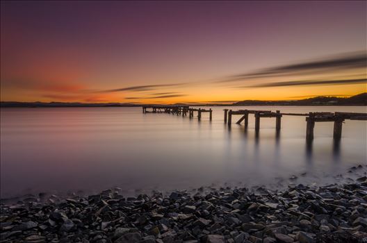 A photograph of the Abandoned pier at Aberdour on the Fife coast taken as the sun sets.