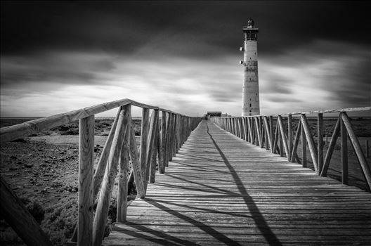 A black and white long exposure photograph of the lighthouse at Morro Jable Jandia Fuerteventura.