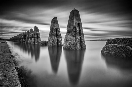 A black & white daytime long exposure photograph of the causeway to Cramond Island in the Firth of Forth.