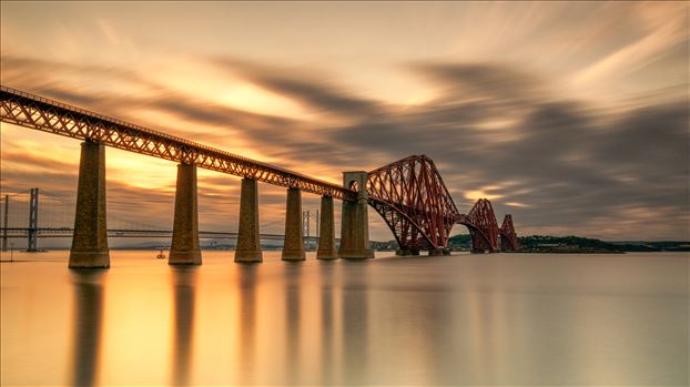 A photograph of the Forth Rail Bridge taken at sunset from South Queensferry.