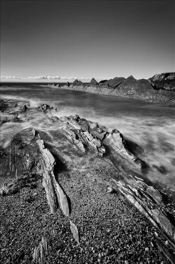 A black and white photograph of the coastline at St Monans of the Fife coast taken at high tide.