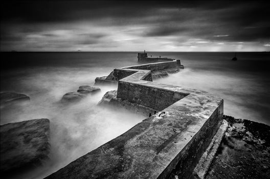 A black and white Photograph of the breakwater at St Monans on the Fife coast.