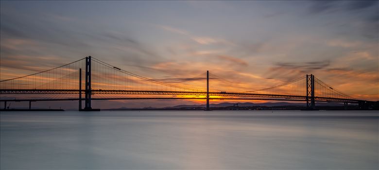 A photograph of the Forth Road Bridge and Queensferry crossing taken at sunset from Hawes Pier South Queensferry.