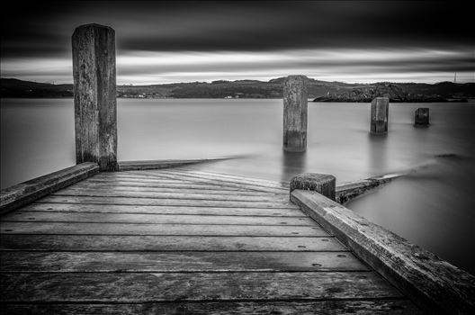 A black and white long exposure photograph taken from the jetty at Inchcolm Island looking towards the Fife coast.