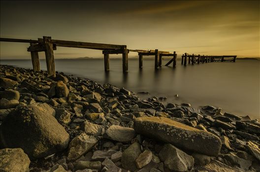 A long exposure photograph of the abandoned  Hawkcraig pier at Aberdour taken at sunset.