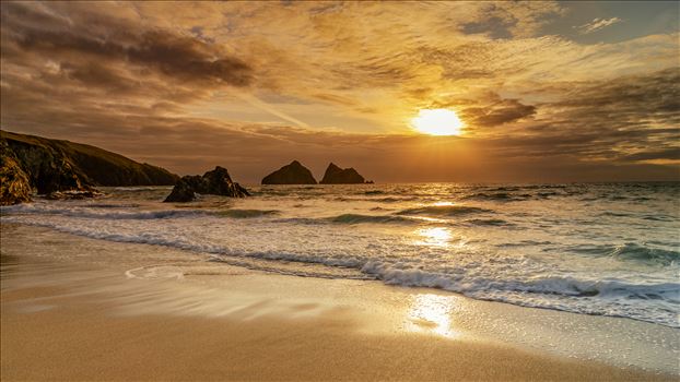 A photograph of Holywell Bay Cornwall taken as the sun sets on a summer evening