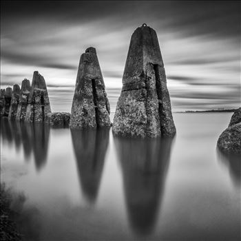 A black & white daytime long exposure photograph of the causeway to Cramond Island in the Firth of Forth.