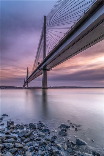 A portrait photograph of the Queensferry Crossing taken from North Queensferry at sunset.