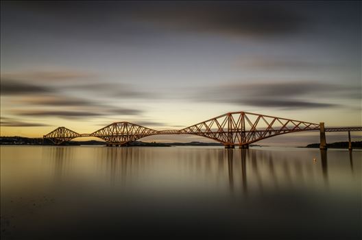 A long exposure photograph of the Forth Rail Bridge taken at sunset from South Queensferry.