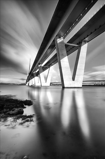 The Crossing Portrait - A black and white long exposure photograph of the Queensferry Crossing taken from the south bank of the river Forth at high tide.